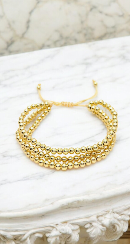 Pulseras dorada de tres vueltas