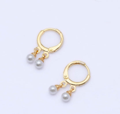 Gold earrings with dangling pearls